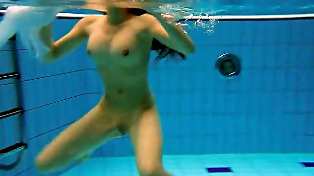 Fit big breasted beauty swims in the pool