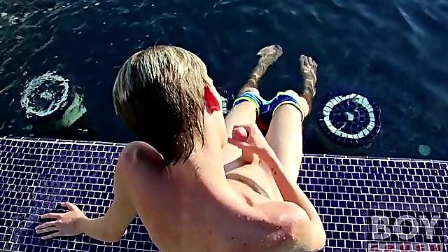 Tall blonde boy masturbates by the pool