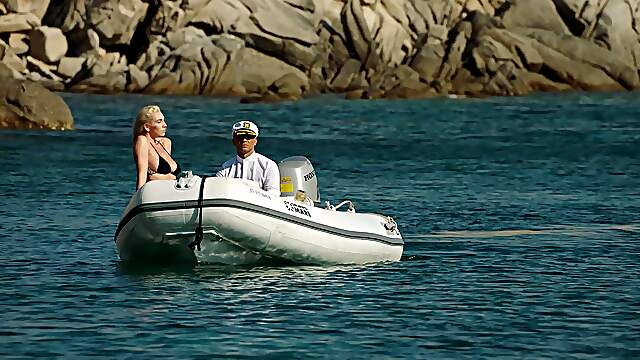 A girl with big boobs is having fun on the beach with her boyfriend.