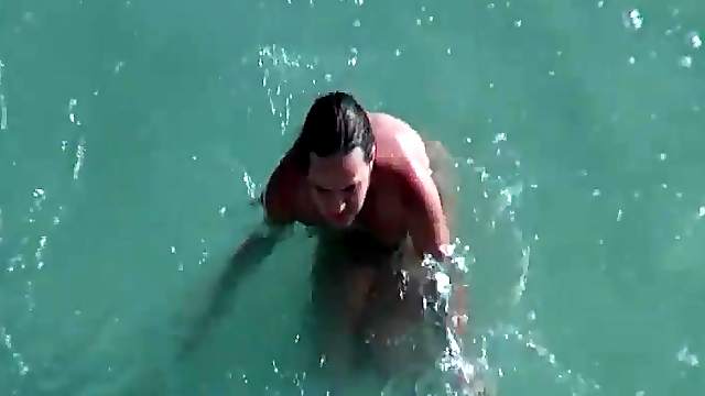Naked girl swimming and relaxing in voyeur beach video
