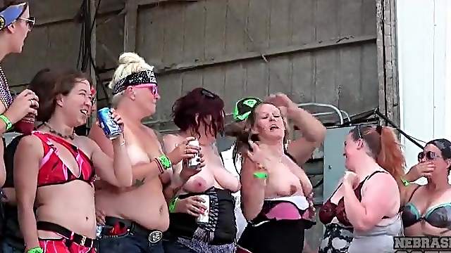 Drunk and chubby party girls dance on stage