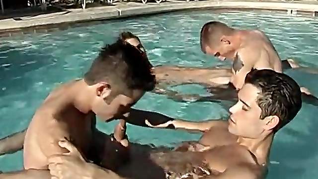 Young gay guys kissing lustily in the pool