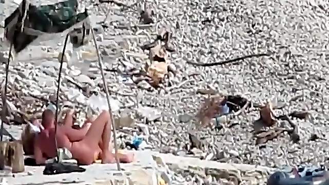 Two guys and a girl have sex on a day at the beach