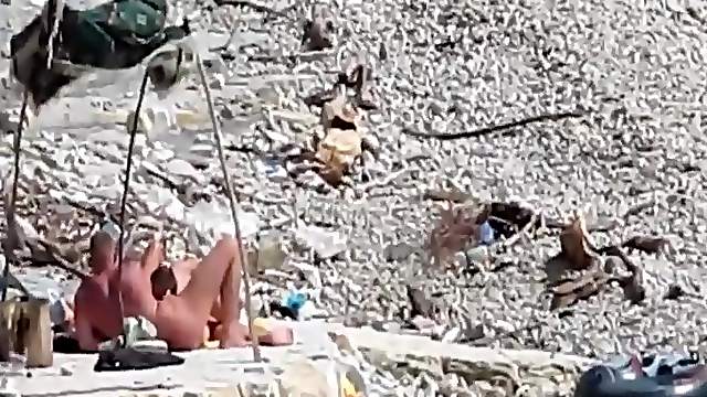 Two guys and a girl have sex on a day at the beach